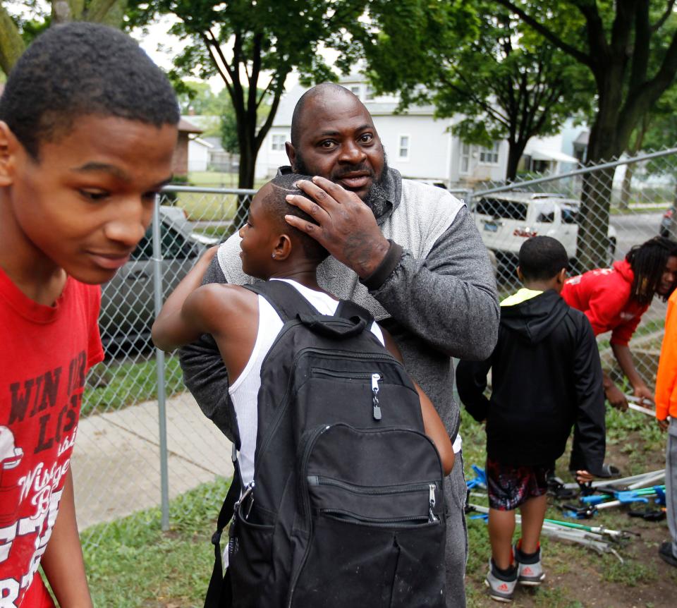 June Thomas greets a youth in 2018 at 