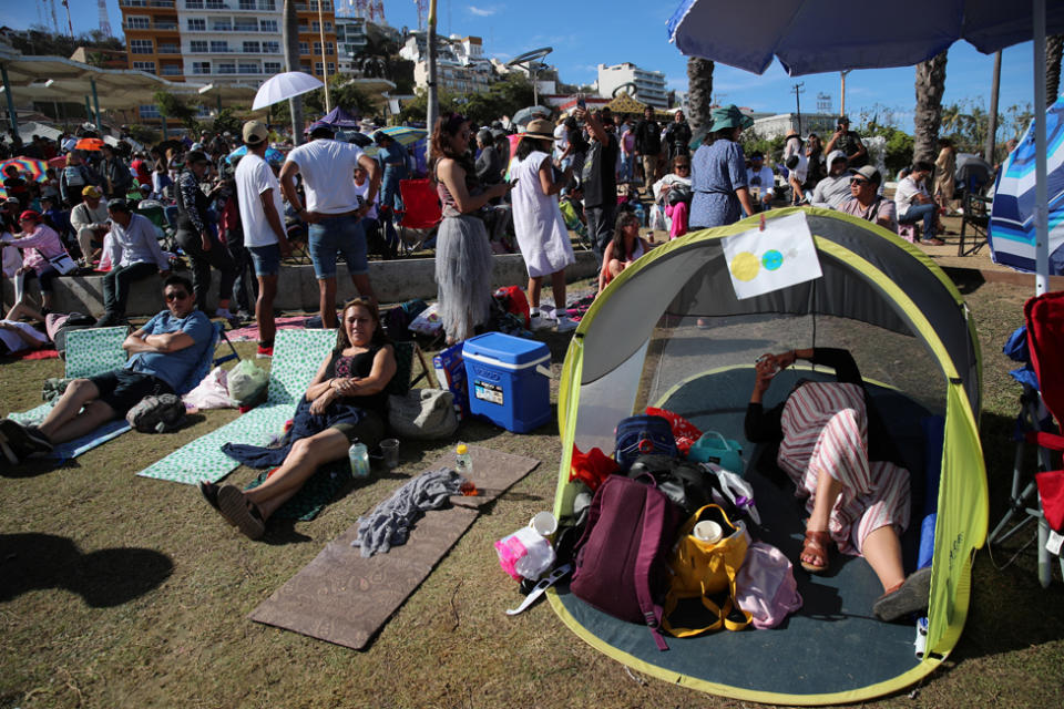 People gather and wait to observe a total solar eclipse in Mazatlan, Mexico April 8, 2024.