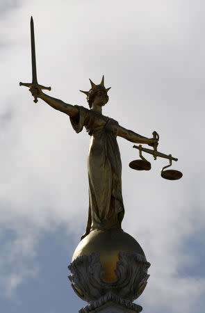 FILE PHOTO:The Lady of Justice is seen on top of the "Old Bailey" Central Criminal Court, in Central London July 10, 2009. REUTERS/Stephen Hird