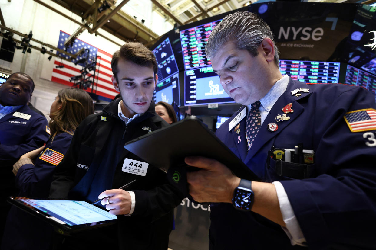 Traders work on the trading floor at the New York Stock Exchange (NYSE) in New York City, U.S., January 27, 2023. REUTERS/Andrew Kelly