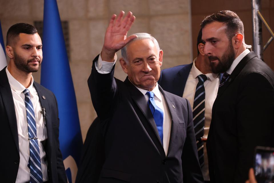 Former Israeli Prime Minister Benjamin Netanyahu waves to his supporters at his party's headquarters in Jerusalem.