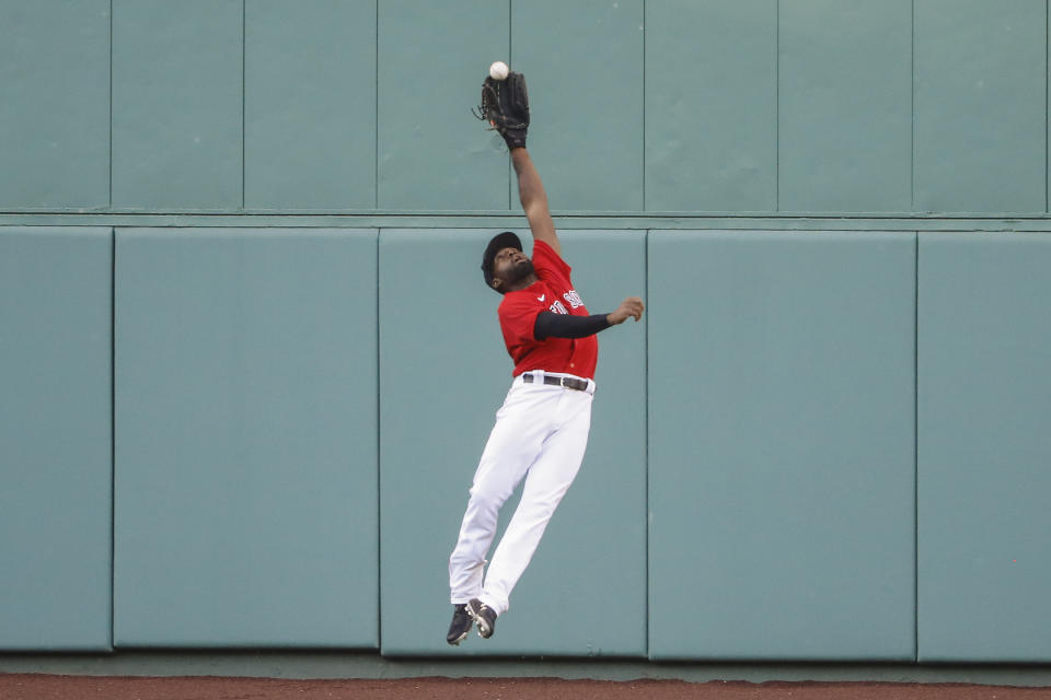 FILE - Boston Red Sox center fielder Jackie Bradley Jr. makes a leaping catch on a ball hit by Toronto Blue Jays' Rowdy Tellez during the sixth inning of the first baseball game of a doubleheader at Fenway Park in Boston, in this Friday, Sept. 4, 2020, file photo. Free-agent outfielder Jackie Bradley Jr. is joining the Milwaukee Brewers, agreeing to the parameters of a $24 million, two-year contract, a person familiar with the negotiations told The Associated Press. The person spoke on condition of anonymity Thursday, March 4, 2021, because the details of the agreement were still being negotiated and the deal is subject to a successful physical.(AP Photo/Winslow Townson, File)