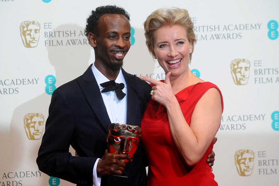 Actor Barkhad Abdi, winner of the Supporting Actor award, and actress Emma Thompson pose in the winners room at the EE British Academy Film Awards 2014 at The Royal Opera House on February 16, 2014 in London, England.