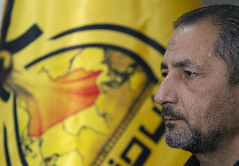 Mohammed Mohieh, the spokesman of Iraq's Iranian-backed Kataeb Hezbollah, or Hezbollah Brigades, gives an interview at his office, in Baghdad, Iraq, Monday, Dec. 30, 2019. Mohieh said Monday that the death toll from U.S. military strikes in Iraq and Syria against its fighters has risen to 25, vowing to exact revenge for the "aggression of evil American ravens." (AP Photo/Nasser Nasser)