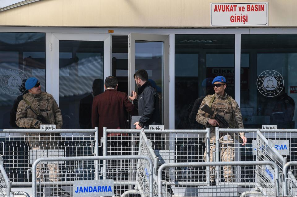Turkish soldiers stand guard as two men enter the Silivri Prison and Courthouse complex in Silivri, near Istanbul on February 18, 2020. / Credit: OZAN KOSE/AFP via Getty Images