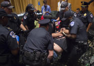 <p>US Capitol Police remove protestors from the US Senate Committee on Finance hearing on the Graham-Cassidy-Heller-Johnson Proposal on reforming health care on Capitol Hill in Washington, DC, September 25, 2017. (Photo: Saul Loeb/AFP/Getty Images) </p>