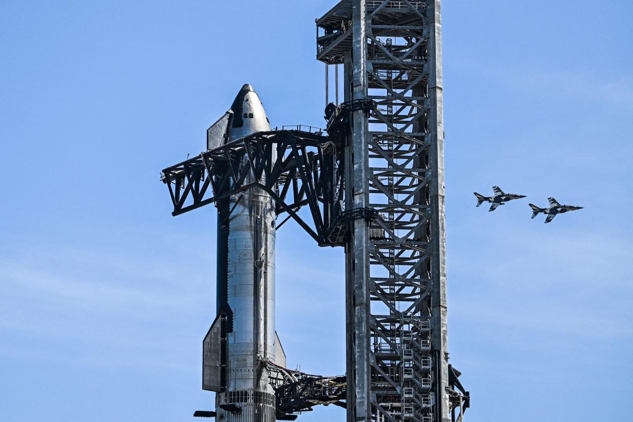 The SpaceX Starship spacecraft can be seen on  as jets fly by in the background ahead of the company's third test flight last month of the massive rocket that will one day ferry astronauts to the moon.