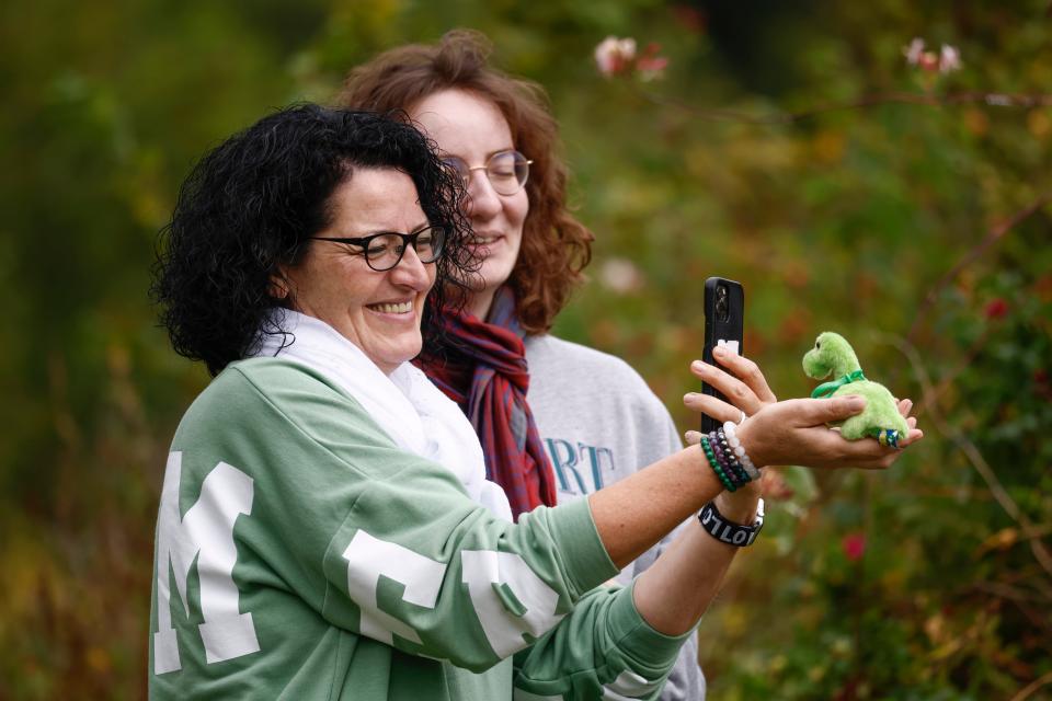 Tourists photograph a souvenir toy of the Loch Ness monster over the weekend of Aug. 27, 2023 in what is described as the biggest search for the Loch ness monster in 50 years.