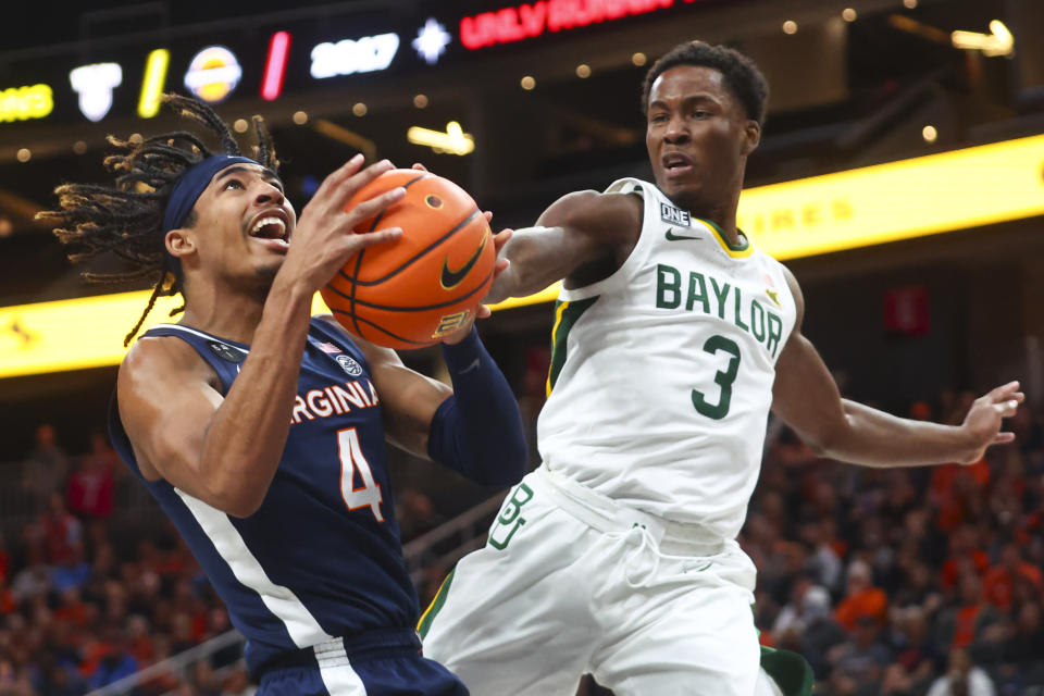 Baylor guard Dale Bonner (3) reaches out to block the shot of Virginia guard Armaan Franklin (4) during the first half of an NCAA college basketball game Friday, Nov. 18, 2022, in Las Vegas. (AP Photo/Chase Stevens)