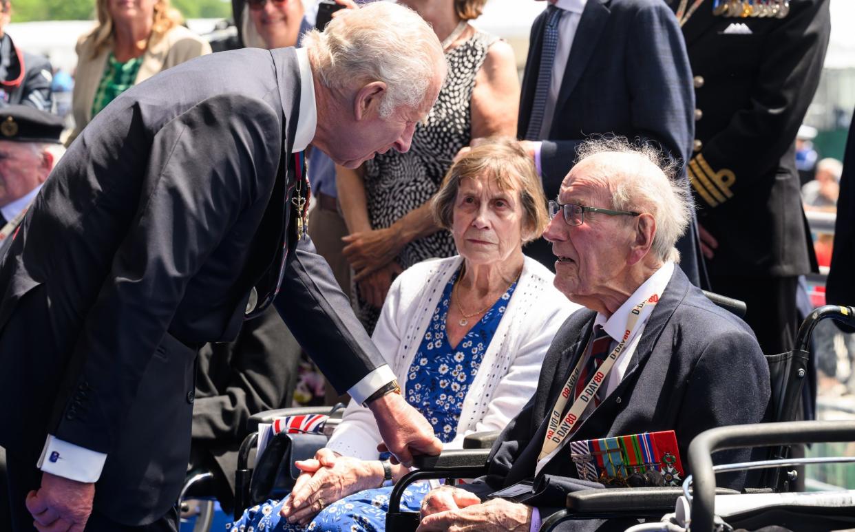 King Charles speaks with a D-Day veteran in Portsmouth