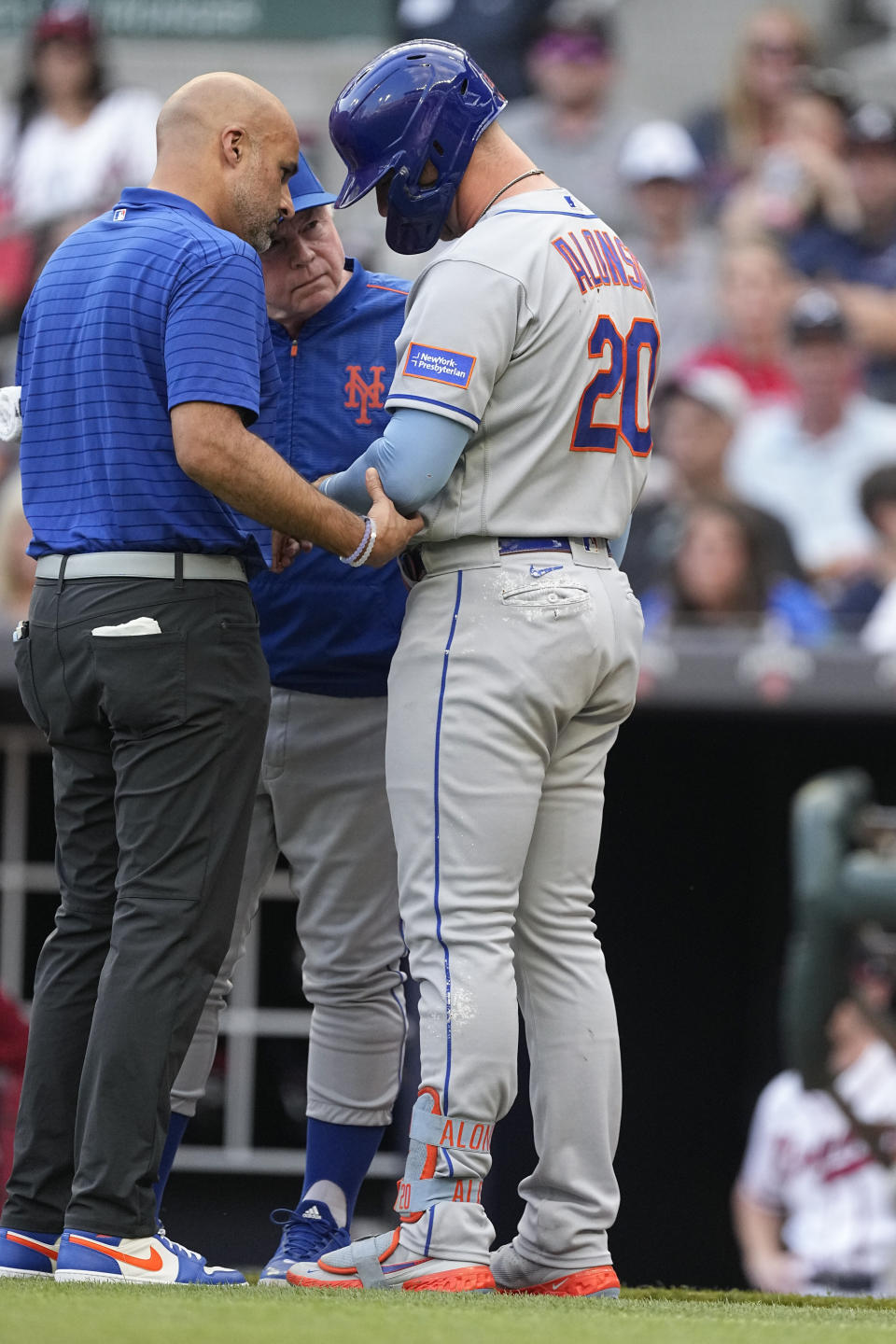 A member of the New York Mets training staff checks first baseman Pete Alonso's (20) hand after he was hit by a pitch from Atlanta Braves starting pitcher Charlie Morton (50) in the first inning a baseball game against the Atlanta Braves, Wednesday, June 7, 2023, in Atlanta. (AP Photo/John Bazemore)