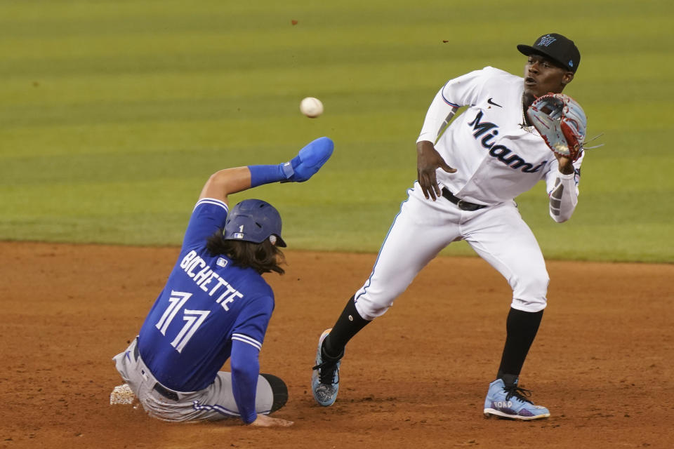 Toronto Blue Jays' Bo Bichette, left, steals second base as Miami Marlins second baseman Jazz Chisholm Jr., right, is late with the catch, during the sixth inning of a baseball game, Tuesday, June 22, 2021, in Miami. (AP Photo/Marta Lavandier)