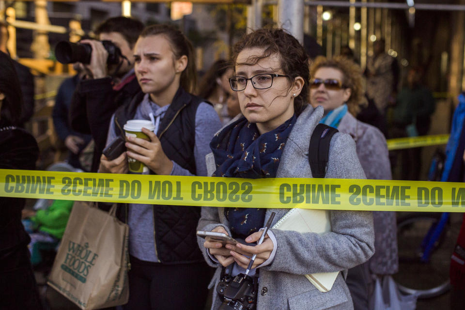 <p>People and media watch the scene after a motorist drove onto a busy bicycle path near the World Trade Center memorial and struck several people, Oct. 31, 2017, in New York. (Photo: Andres Kudacki/AP) </p>