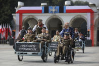 Warsaw's Uprising veterans attend the ceremony marking the Polish Army Day in Warsaw, Poland, Monday, Aug. 15, 2022. The Polish president and other officials marked their nation's Armed Forces Day holiday Monday alongside the U.S. army commander in Europe and regular American troops, a symbolic underlining of NATO support for members on the eastern front as Russia wages war nearby in Ukraine. (AP Photo/Michal Dyjuk)