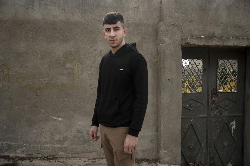 Khaled Shitawi, 17, who was was arrested last March in a night raid on the family home, poses for a portrait in the West Bank town of Kfar Qaddum, Friday, Jan. 13, 2023. "This is the darkest moment," said activist Murad Shitawi. "I'm worried for my sons." (AP Photo/ Maya Alleruzzo)