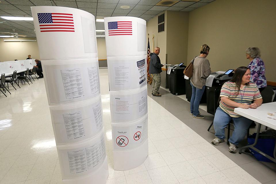 Voters place their ballots in the ballot scanners after voting at the Ashland Fraternal Order of Eagles #2178 polling place on Eastlake Drive on Tuesday morning, Nov. 8, 2022. TOM E. PUSKAR/ASHLAND TIMES-GAZETTE