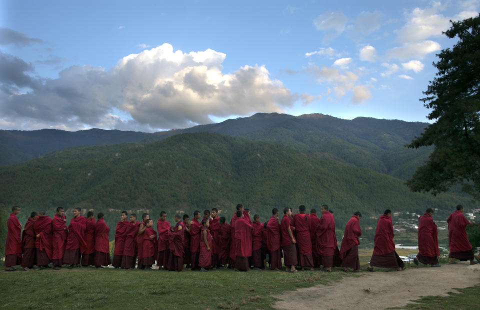 THIMPHU, BHUTAN - OCTOBER 18: Monks line up for dinner at the Dechen Phodrang monastery October 18, 2011 in Thimphu, Bhutan. About 375 monks reside at the government run monastery that also doubles as a child care facility for under privileged and orphaned males. The monks average about 10 hours of study a day waking up at 5:00am. Mahayana Buddhism is the state religion, although in the southern areas many citizens openly practice Hinduism. Monks join the monastery at six to nine years of age and according to tradition many families will send one son into the monk hood. They learn to read chhokey, the language of the ancient sacred texts, as well as Dzongkha and English. (Photo by Paula Bronstein/Getty Images)