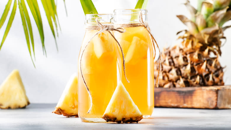 Pineapple cores in bottles of water