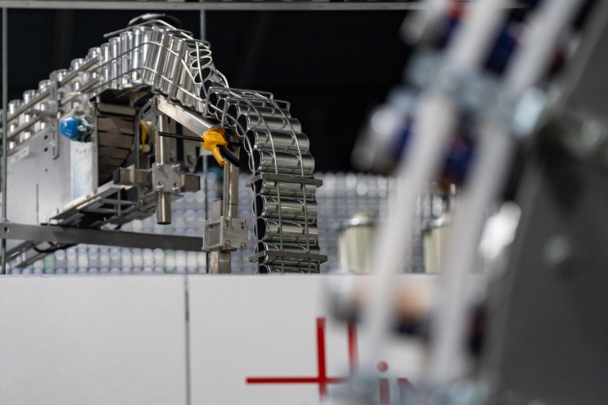 Cans make their way down an assembly line to be digitally printed with branding artwork at Canworks Wednesday, Jan. 16, 2024. The facility prints branding artwork onto thousands of aluminum cans a day, helping businesses across the country.