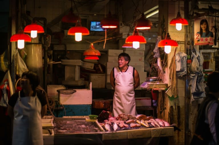 A fishmonger waits for customers in the Wanchai district of Hong Kong on November 3, 2015