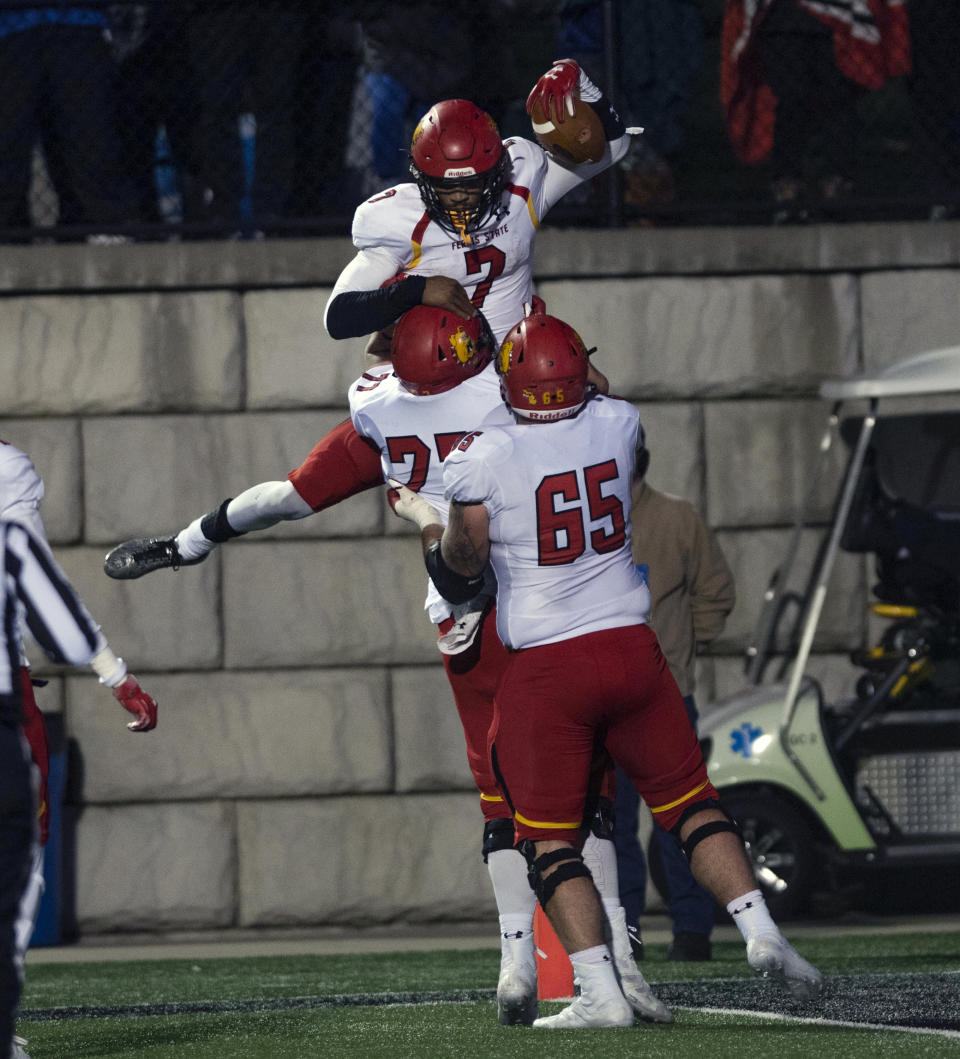 In this Oct. 13, 2018, photo, Ferris State quarterback Jayru Campbell (7), top, celebrates with teammates after a touchdown against Grand Valley State during an NCAA college football game in Grand Rapids, Mich. Ferris State defeated Grand Valley State 35-31. Campbell, who has led the Bulldogs to the national championship game, highlights The Associated Press Division II All-America team along with two of his teammates. Campbell, a junior, has passed for 2,832 and 26 touchdowns and run for 1,338 and 20 scores, leading Ferris State to a 15-0 record heading into the D-II championship game against Valdosta State on Saturday. (Alyssa Keown/The Grand Rapids Press via AP)