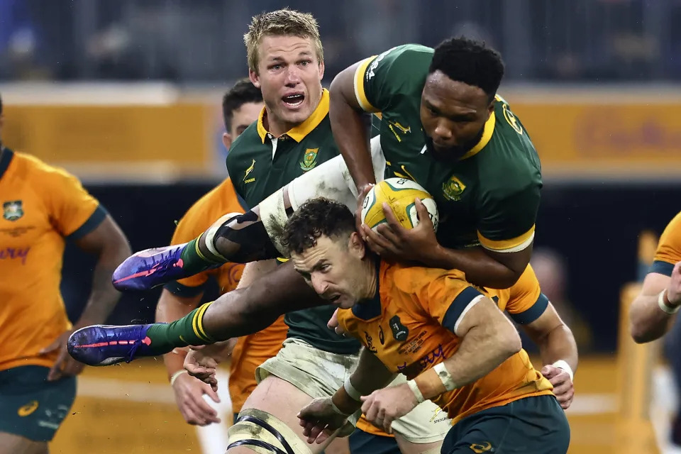 South Africa's Lukhanyo Am, top right, falls over Australia's Nic White during their rugby union test match in Perth, Saturday, Aug. 17, 2024. (AP Photo/Trevor Collens)