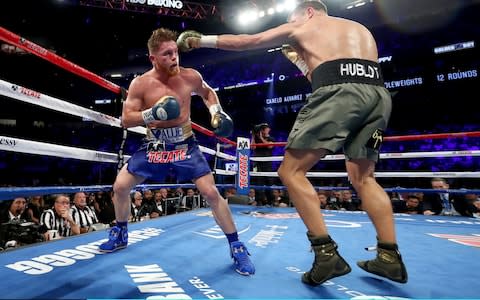 Gennady Golovkin throws a punch at Canelo Alvarez  - Credit: Getty