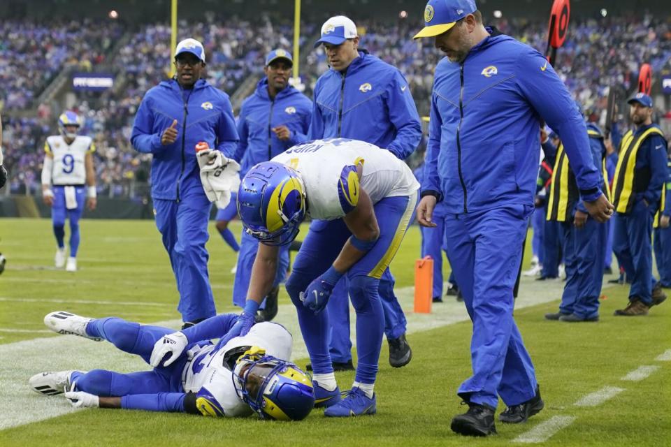 Rams receiver Tutu Atwell is on the ground after suffering a concussion. Cooper Kupp checks on his teammate.