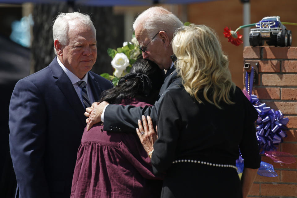 FILE - President Joe Biden and first lady Jill Biden comfort Principal Mandy Gutierrez as Superintendent Hal Harrell stands next to them, at a memorial outside Robb Elementary School to honor the victims killed in a school shooting in Uvalde, Texas, May 29, 2022. (AP Photo/Dario Lopez-Mills, File)