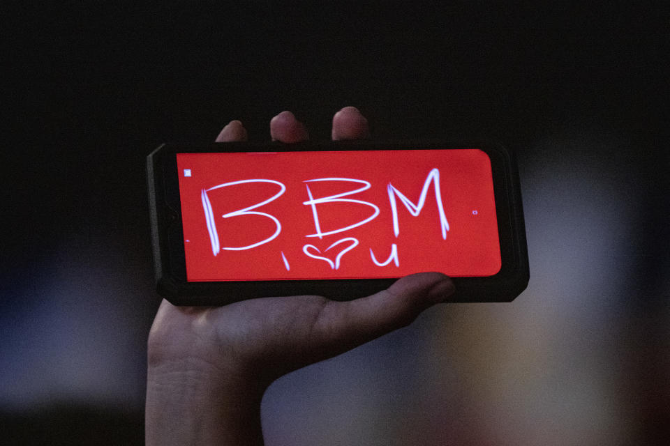 The power of love. A supporter holds up a phone with the initials of Ferdinand 