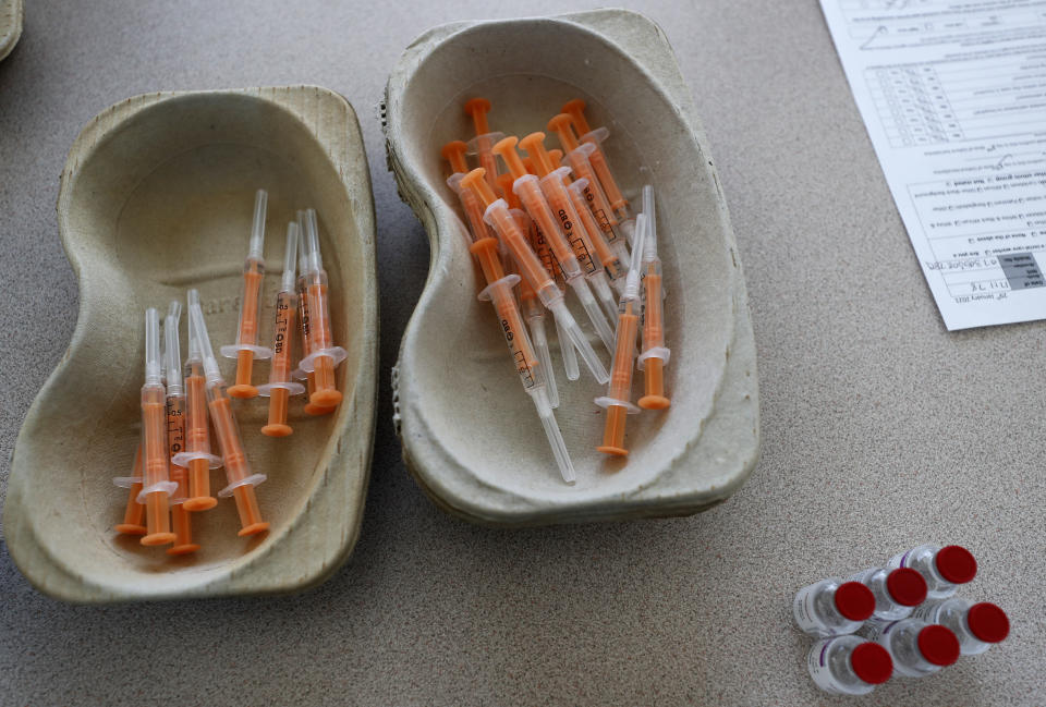 Vials of the AstraZeneca vaccine and loaded syringes wait to be administered to homeless persons at the Welcome Centre in Ilford, east London, Friday, Feb. 5, 2021. (AP Photo/Frank Augstein)