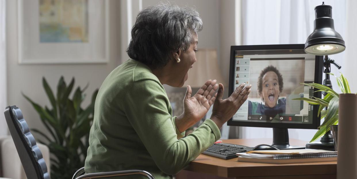 a grandma video chats with her grandson on a computer