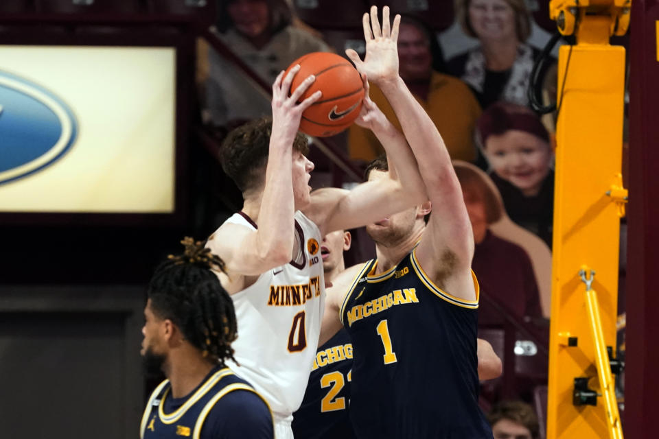 Minnesota's Liam Robbins (0) eyes the basket as Michigan's Hunter Dickinson (1) defends in the second half of an NCAA college basketball game, Saturday, Jan. 16, 2021, in Minneapolis. (AP Photo/Jim Mone)