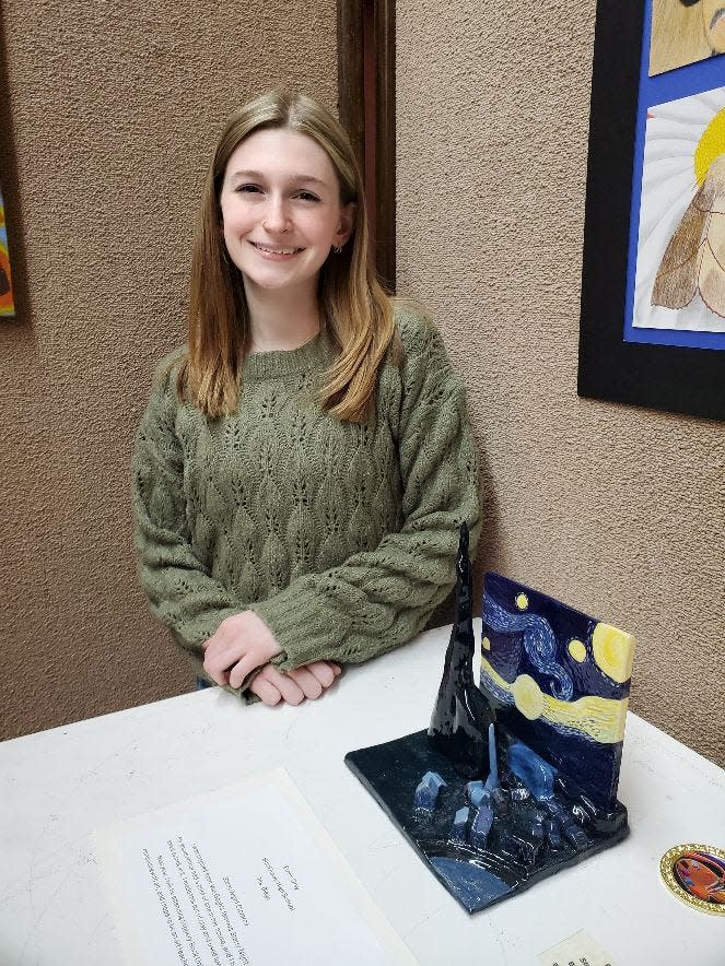 Emily Gray, a Blackhawk High student, poses with her award-winning artwork, "Starry Night Drama."