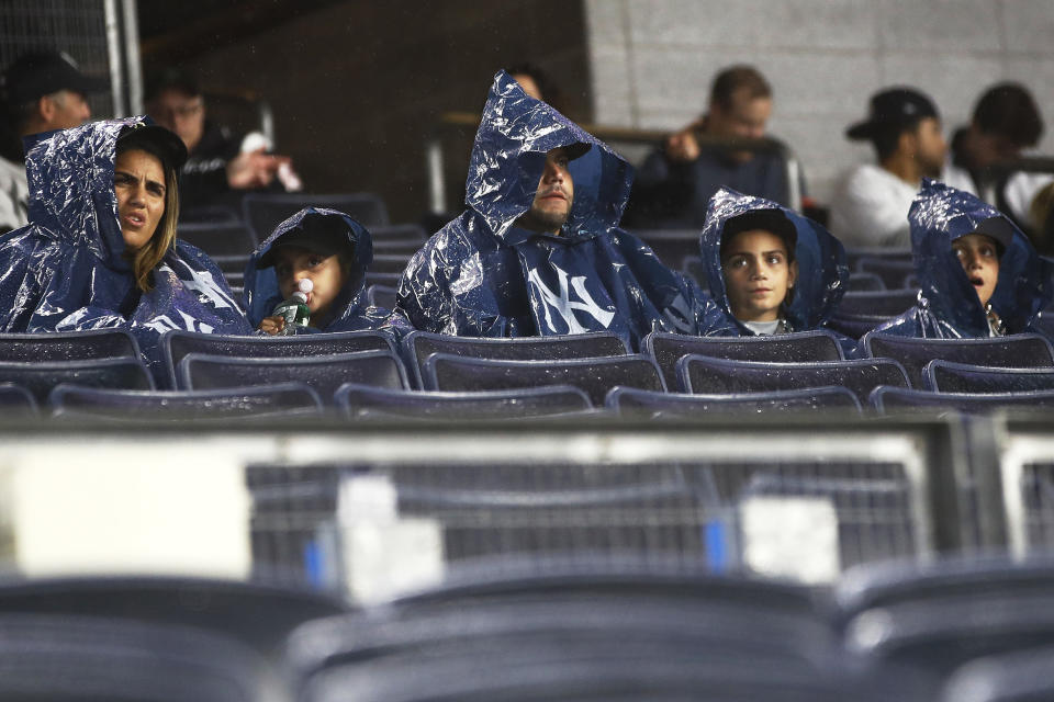 NEW YORK, NEW YORK - OCTOBER 17: New York Yankees fans look on from the stands during a rain delay prior to playing the Cleveland Guardians in game five of the American League Division Series at Yankee Stadium on October 17, 2022 in New York, New York. (Photo by Sarah Stier/Getty Images)