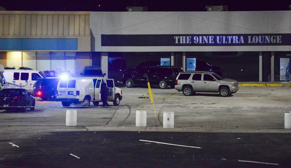 Kansas City, Mo., police crime scene investigators gather evidence at the scene of a shooting outside a nightclub in the early hours of Jan. 20, 2020. Police say an armed security guard shot and killed a man suspected of fatally shooting a woman and injuring 15 more people in a shooting there.