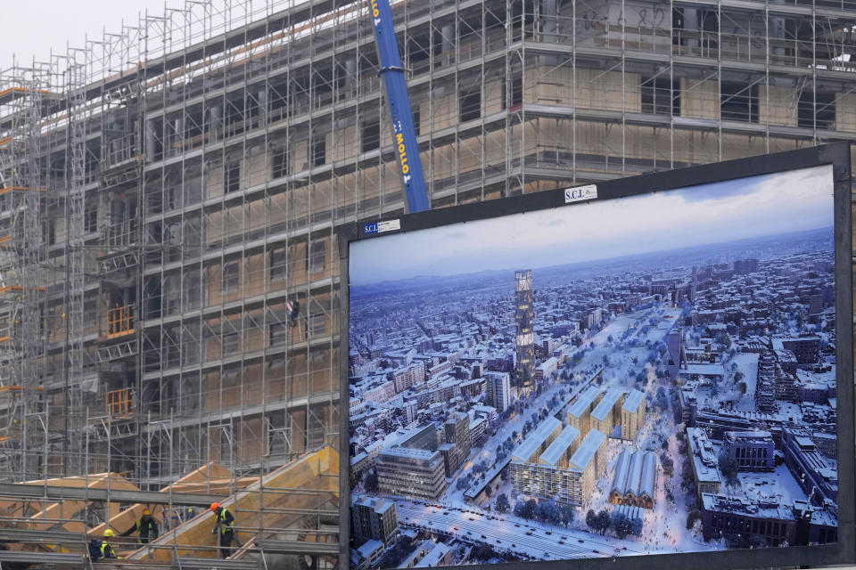 Workers build the Olympic Village at the Porta Romana former railway yard, in Milan, Italy, Tuesday, Feb. 6, 2024. The 2026 Milan-Cortina Olympics start exactly two years from Tuesday and it still seems like there are more questions than answers for a complicated games that will be staged across a large swath of northern Italy spread between five different venue clusters. (AP Photo/Antonio Calanni)