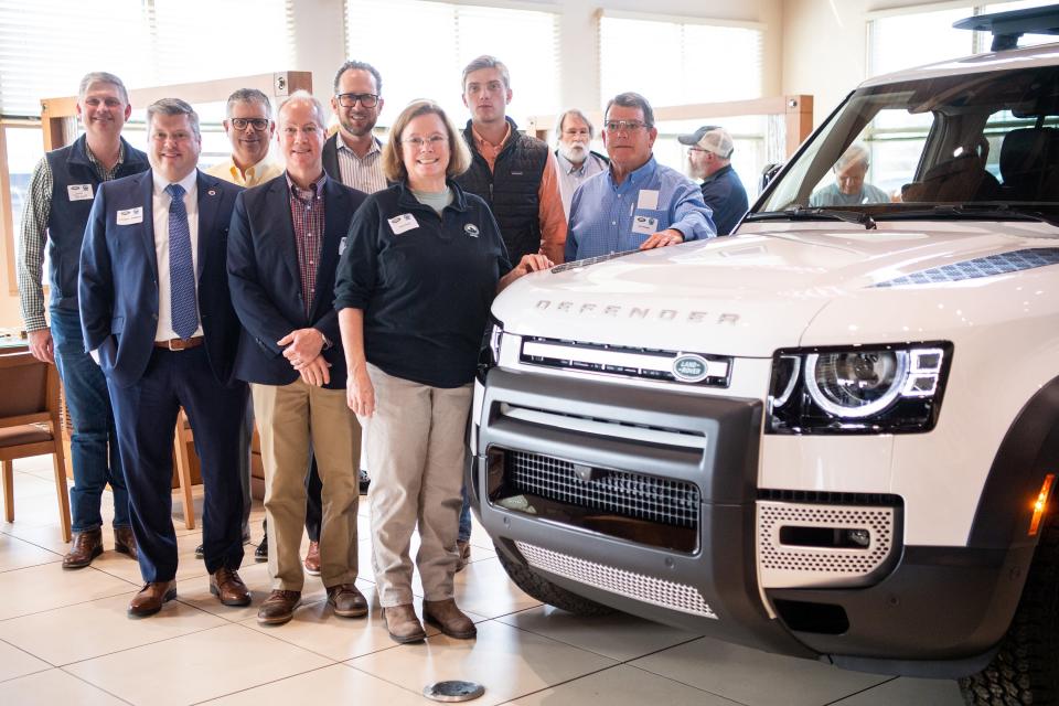 Appalachian Bear Rescue executive director Dana Dodd takes a photo with Townsend Mayor Donald Prater, Land Rover representatives and the Land Rover Defender 130 SUV awarded to ABR as part of Land Rover USA's Defender Service Awards. The event at Land Rover Knoxville was on Tuesday, Feb. 21, 2023.