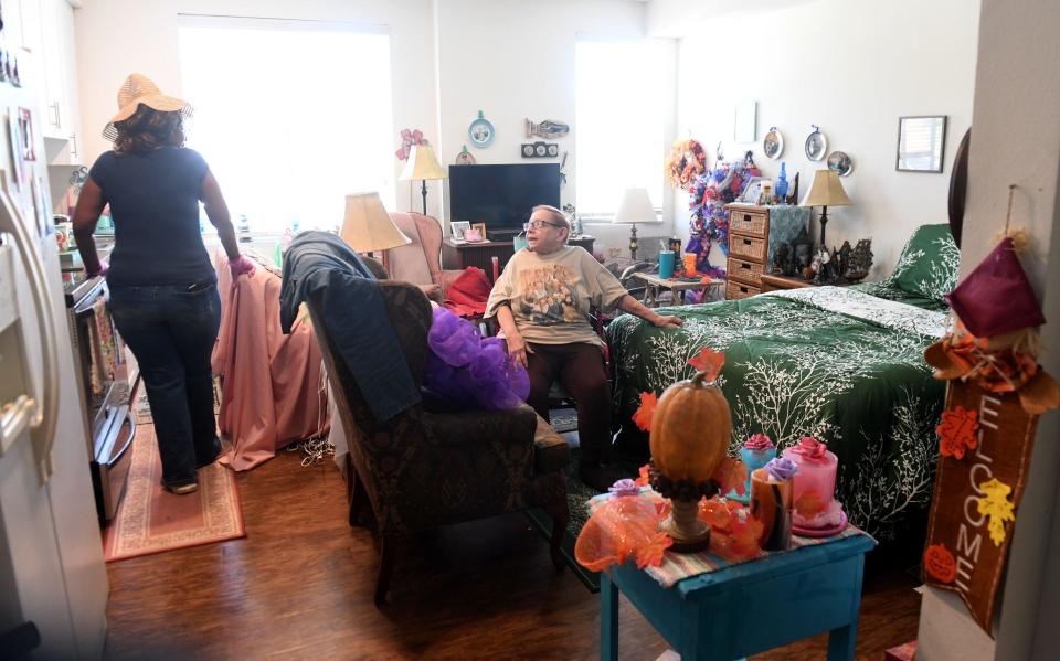Marie Smith, 78, of Oxnard, talks with her caregiver in her studio apartment on Nov. 22. Social Security doesn't provide enough money for Smith to pay her rising rent.