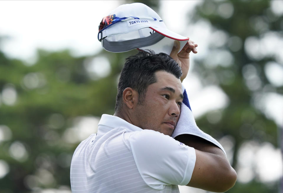 Hideki Matsuyama of Japan dries his sweat on10th hole during the second round of the men's golf event at the 2020 Summer Olympics on Friday, July 30, 2021, at the Kasumigaseki Country Club in Kawagoe, Japan. (AP Photo/Matt York)