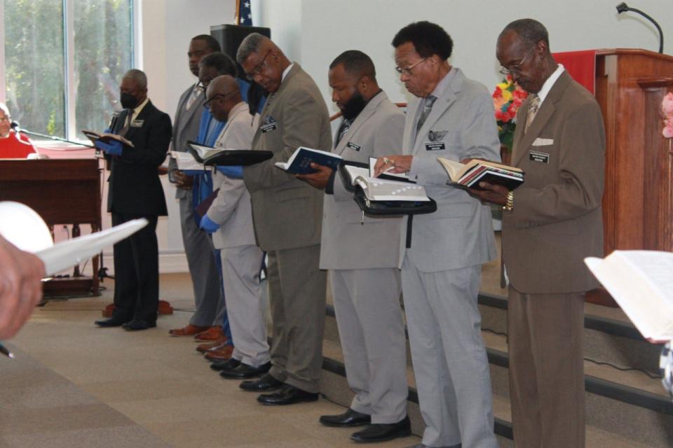 The deacons of DaySpring Baptist Church lead devotion during a service Sunday morning celebrating the church's 108th anniversary.