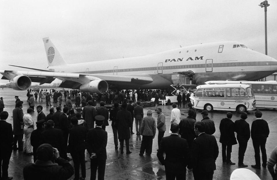 FILE - In this Jan. 12, 1970 file photo, a crowd is gathered at London's Heathrow Airport in England after a Pan Am Boeing 747 Jumbo Jet arrived in from New York. The 360 seat jet was the first of its kind to complete a transatlantic crossing. For decades, the Boeing’s 747 was the Queen of the Skies. But the glamorous double-decker jumbo jet that revolutionized air travel and shrunk the globe could be nearing the end of the line. (AP Photo, File)