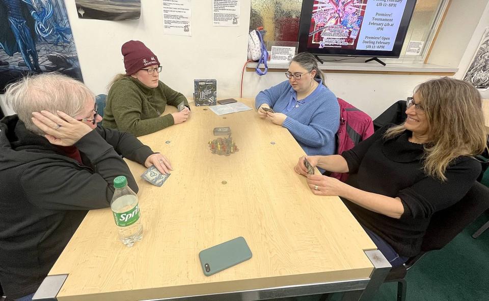 From left, Maggie Forsell-VanHorn, Erin Paquette, Karen Biebel and Lisa Peterson play "Uk'otoa" during Erie Board Games' weekly gathering at Gateway Games on Jan. 25.