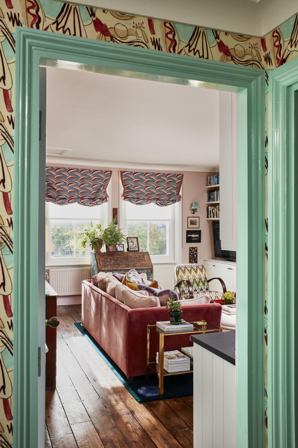 Pink living room with pastel blue woodwork