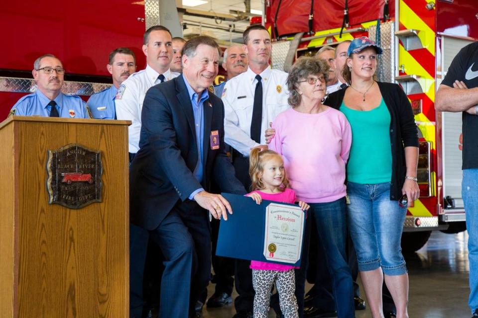 NC Insurance Commissioner Mike Causey presents an award of ‘heroism’ to 5-year-old Taylor Carroll who alerted her grandmother to smoke coming from their laundry room and the Angier-Black Rive Fire Department was able to contain the blaze, on Oct. 24, 2019, in Angier, NC.