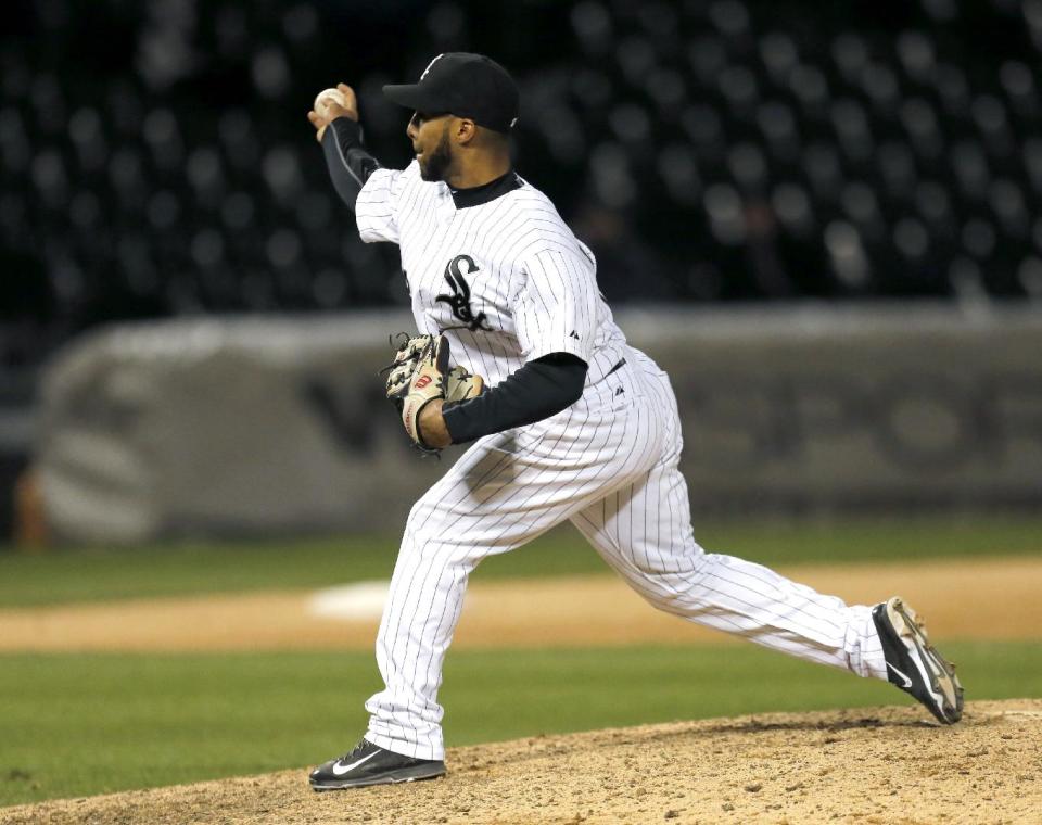 Chicago White Sox second baseman Leury Garcia, pitches in relief during the 14th inning of a baseball game against the Boston Red Sox Thursday, April 17, 2014, in Chicago. The Red Sox won 6-4. (AP Photo/Charles Rex Arbogast)