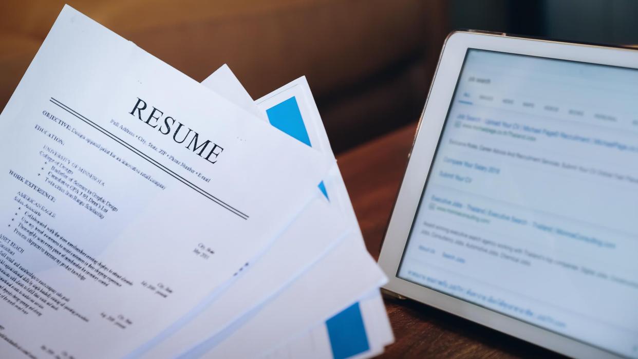 woman holding resume application with using tablet digital to job search on internet.