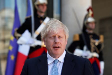 British Prime Minister Boris Johnson delivers a joint statement with French President Emmanuel Macron before a meeting on Brexit at the Elysee Palace in Paris