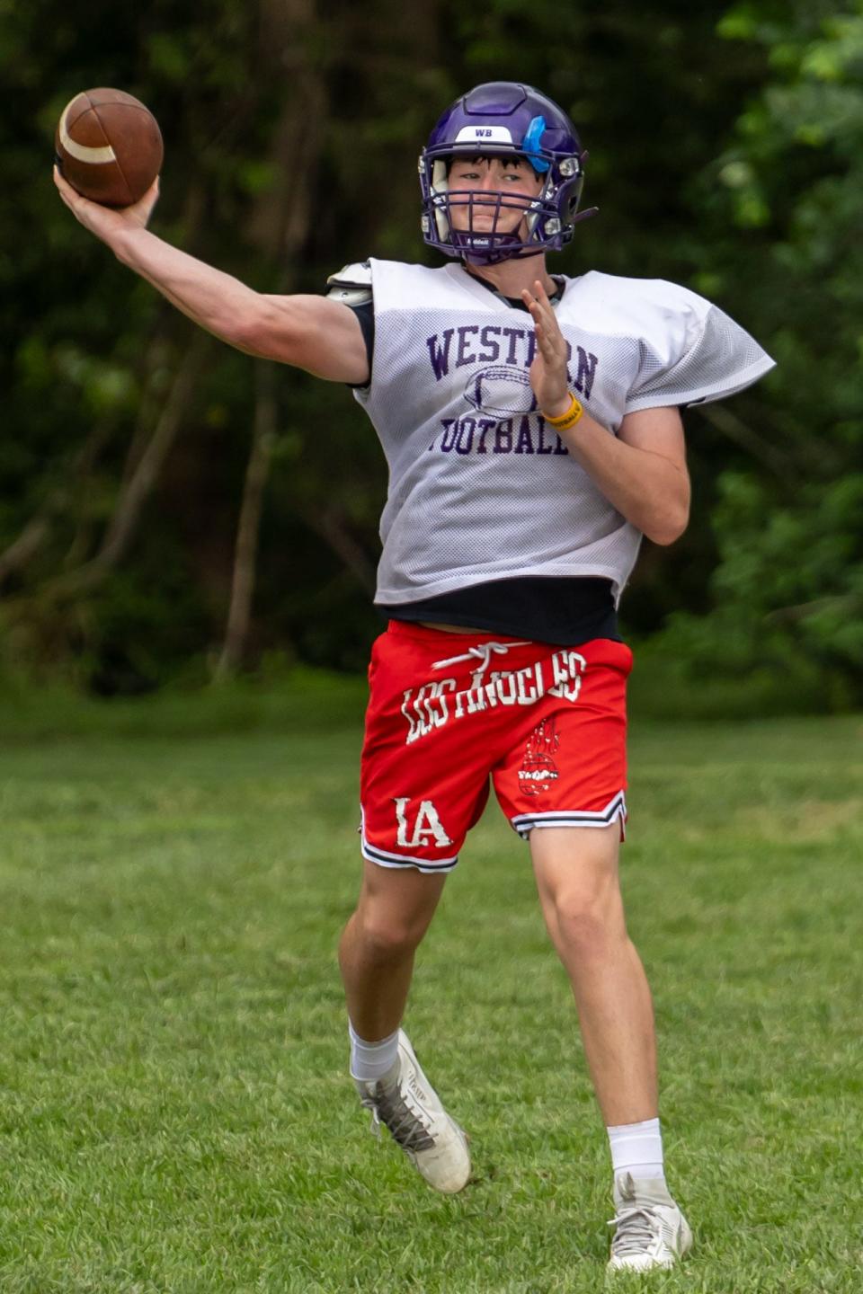 Western Beaver quarterback Jaivin Peel throws the ball down the field during the team's heat acclimatization practice Aug. 8 at Western Beaver High School.