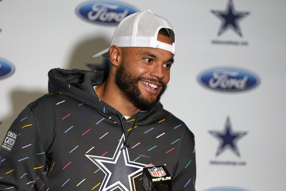 Dallas Cowboys quarterback Dak Prescott talks to reporters